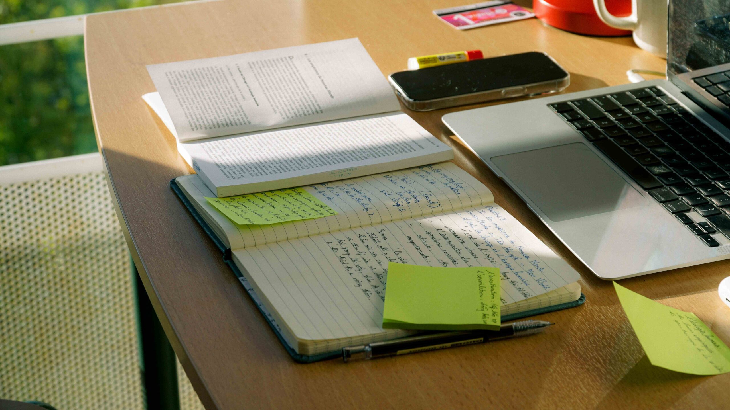Sticky notes on a book and laptop