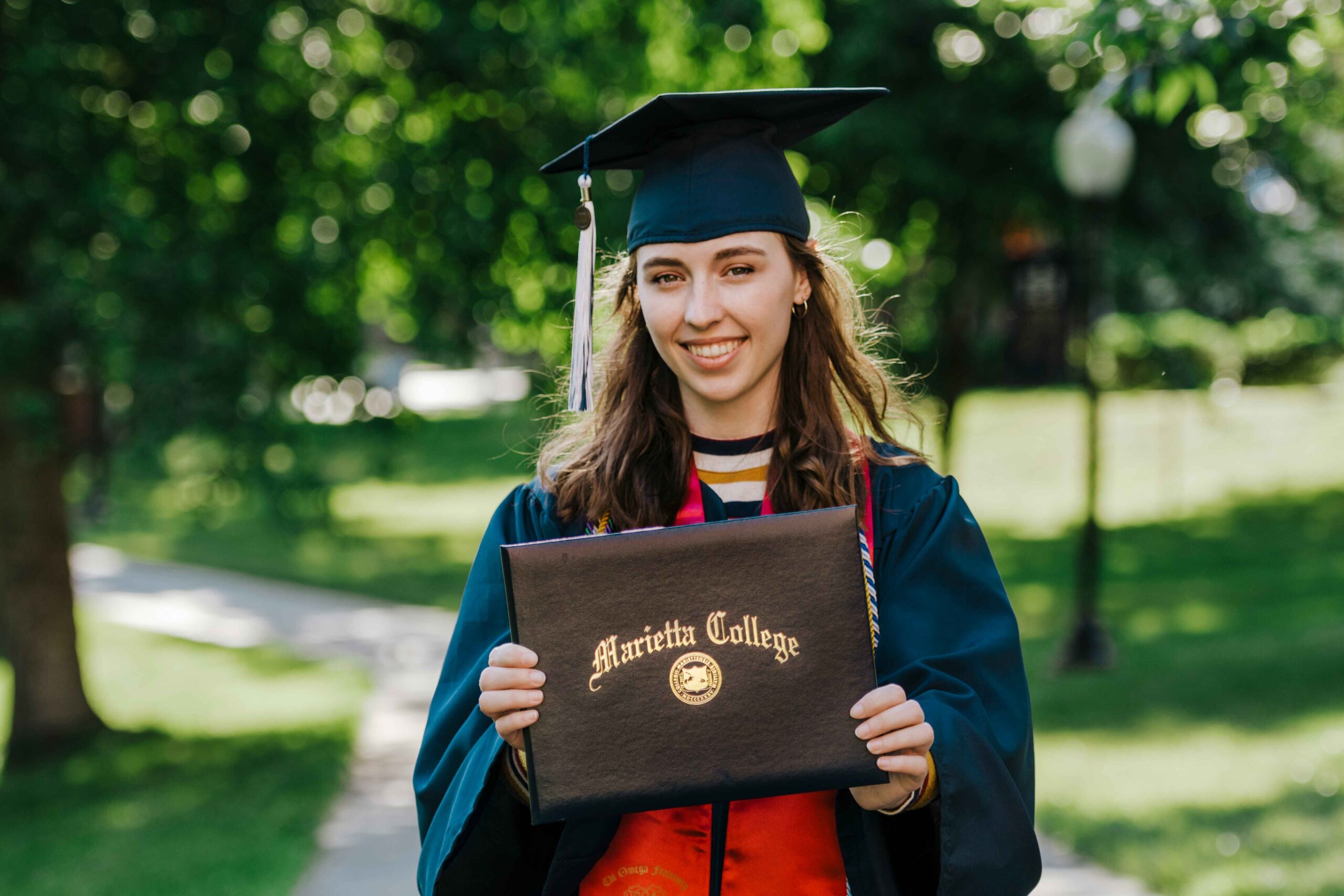 A student holding a degree certificate