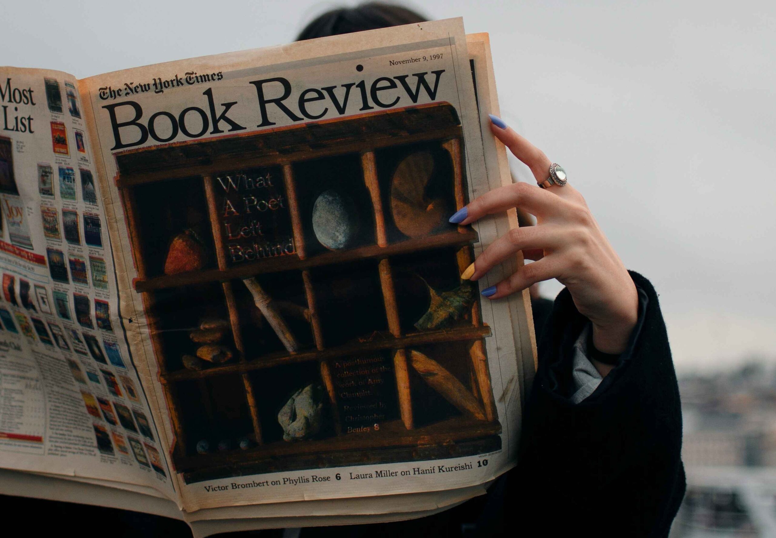 Student reading a book review
